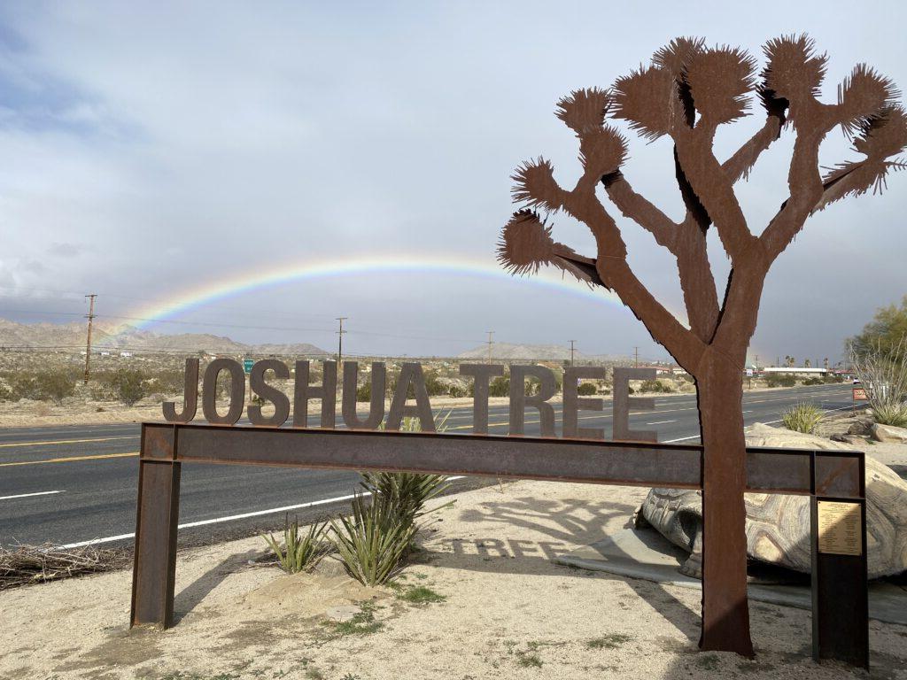 Photo of downtown Joshua Tree sign with rainbow
